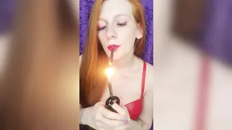 redhead beauty smokes a pink cigarette, purple makeup