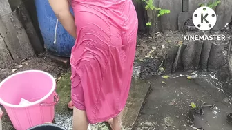 Indian house wife bathing outside