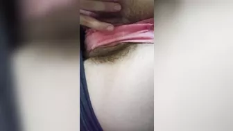 Tease in pink panties, hairy pussy lips.