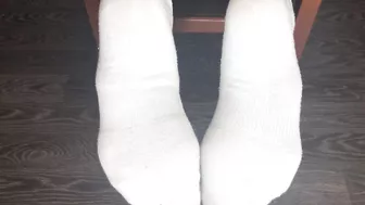 STUDENT GIRL SHOWS WHITE SOCKS AND FEET AFTER STUDYING.