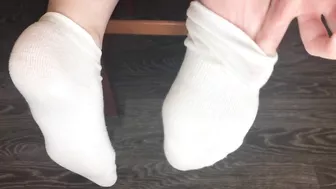 STUDENT GIRL SHOWS WHITE SOCKS AND FEET AFTER STUDYING.