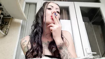 Dominatrix Nika smokes a cigarette and blows smoke in your face. Smoking fetish. The fetish of cigarette smoke.