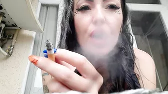 Dominatrix Nika smokes a cigarette and blows smoke in your face. Smoking fetish. The fetish of cigarette smoke.