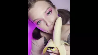 Lucky banana in the mouth of a girl with braces. Eye contact