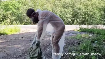 Girl in transparent overalls clean up trash in public