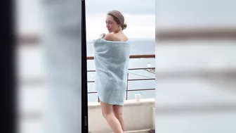 Sexy slender girl flashes her natural bare breasts on her balcony.