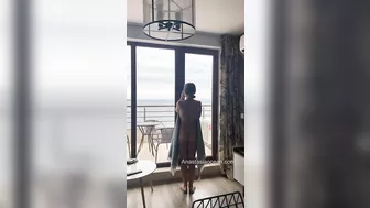 Sexy slender girl flashes her natural bare breasts on her balcony.