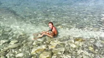 Slender tanned blonde gets fucked on the beach by the sound of waves during a photo shoot