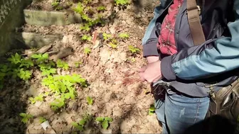 Bearded guy pissing in the forest. A man relieves himself in nature