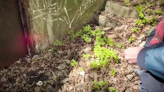 Bearded guy pissing in the forest. A man relieves himself in nature