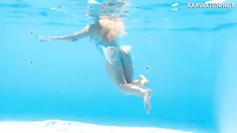 Her body cutting through the shimmering water of the pool