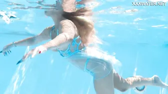 Her body cutting through the shimmering water of the pool