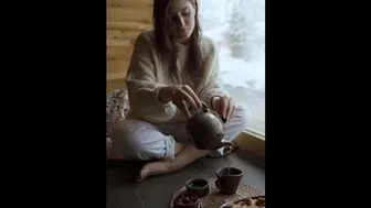 A girl filling tea into a classic cup