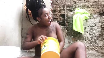 Black woman from Bahia bathing in a bucket in the backyard.