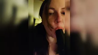 Sucking a big black dildo