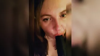 Sucking a big black dildo