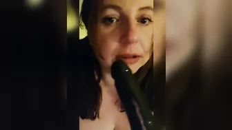 Sucking a big black dildo