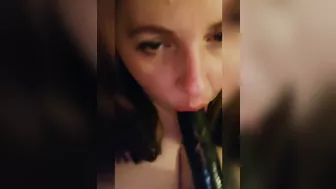 Sucking a big black dildo