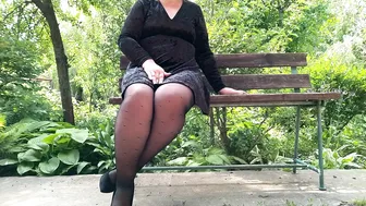 Naughty milf in pantyhose pissing in the park on a bench rear view