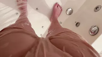 Girl using shower after wetting accident in shorts