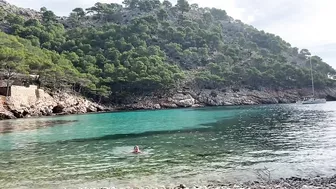 girl swimming on a public beach completely naked