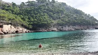 girl swimming on a public beach completely naked