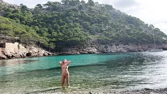 girl swimming on a public beach completely naked