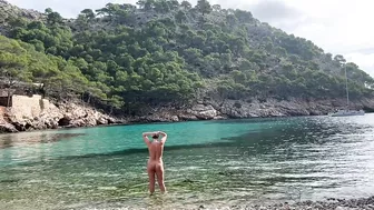 girl swimming on a public beach completely naked