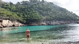 girl swimming on a public beach completely naked