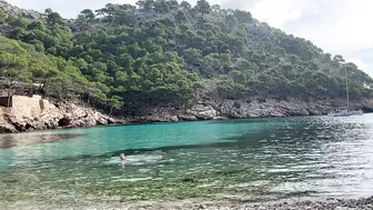 girl swimming on a public beach completely naked