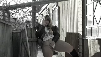 A mature fat milf smokes and shows her tits and pussy in the courtyard of an abandoned house.