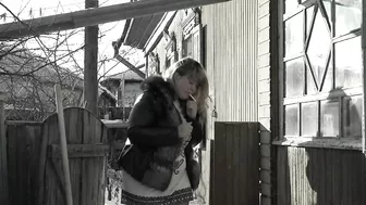 A mature fat milf smokes and shows her tits and pussy in the courtyard of an abandoned house.