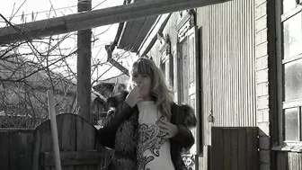 A mature fat milf smokes and shows her tits and pussy in the courtyard of an abandoned house.