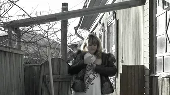 A mature fat milf smokes and shows her tits and pussy in the courtyard of an abandoned house.