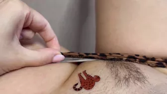 Tattoo master in leopard panty doing temporary tattoo