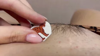 Tattoo master in leopard panty doing temporary tattoo