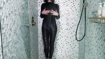 Skintight black catsuit tease