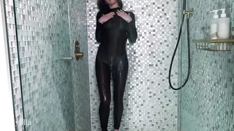 Skintight black catsuit tease