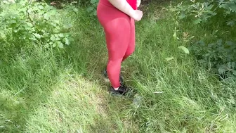 A beauty in leggings pees in nature