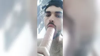 Sucking a big fat dildo